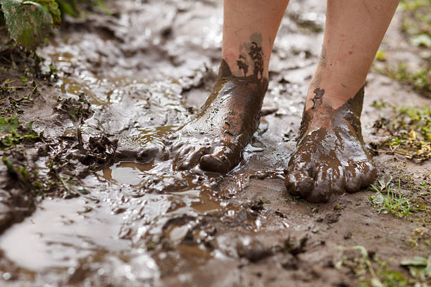 Feet in mud stock photo