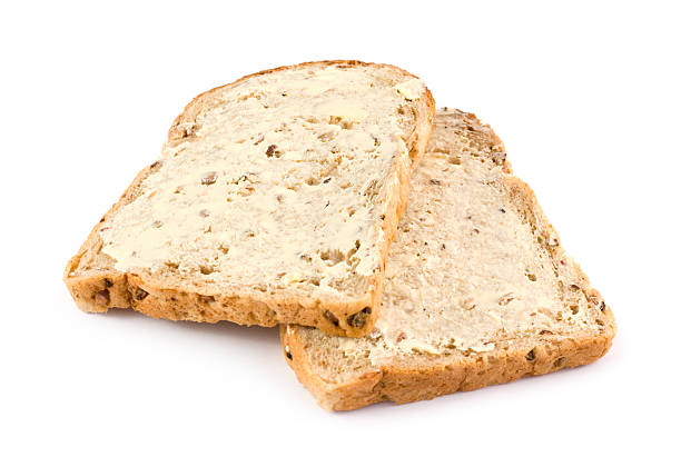 istock Wholemeal brown bread with butter on a white background 471442847