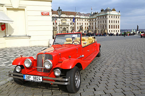 PRAGUE, CZECH REPUBLIC - APRIL 21, 2017: Two vintage Ford cars parked in front of a Cartier shop in the Parizska street, offering sightseeing tours for tourists