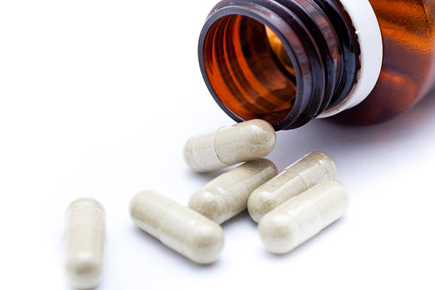 istock Prescription Medication Bottle Spilling capsules 471443103