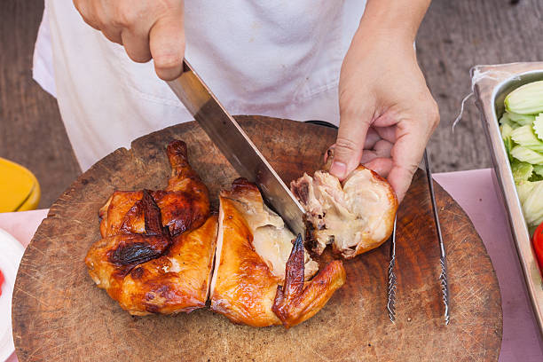 istock Chef are using Kitchen knife chicken grilled on wood block 471443900