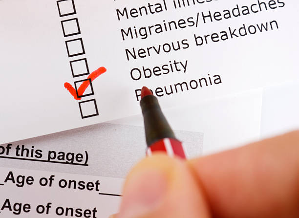 istock Obesity checked from a list of items with a red pen 471445357