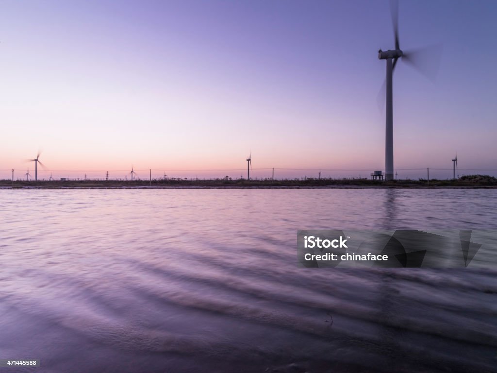 wind turbine and electrical towers on sunset 2015 Stock Photo