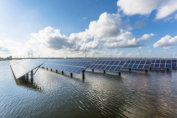 istock solar energy panels and wind turbines 471445608