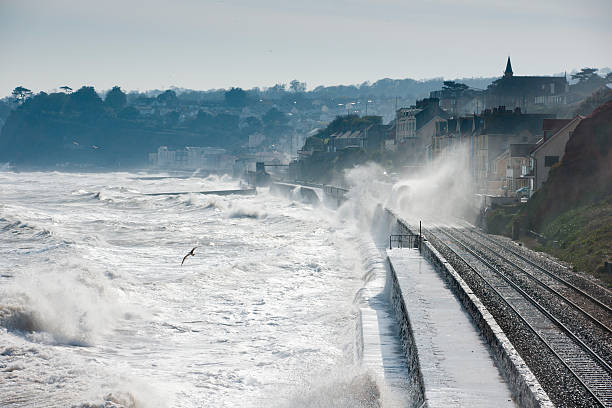 istock Waves breaking over train at Dawlish Devon in stormy seas 471445655