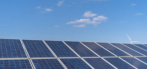 istock solar energy panels and wind turbines 471445694