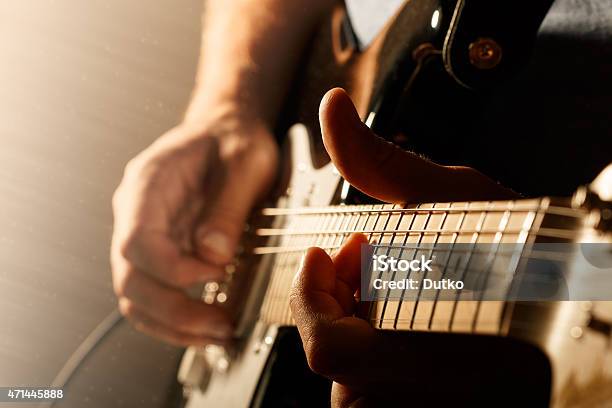 Close Up Of Mans Fingers Playing Electric Guitar Stock Photo - Download Image Now - Guitar, Electric Guitar, Playing