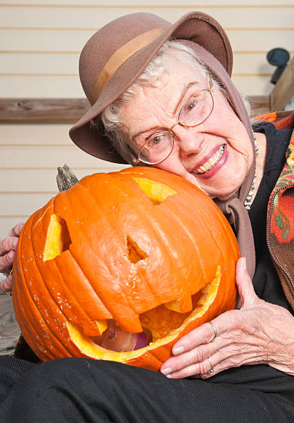 istock Senior woman and dear old jack o lantern 471446053