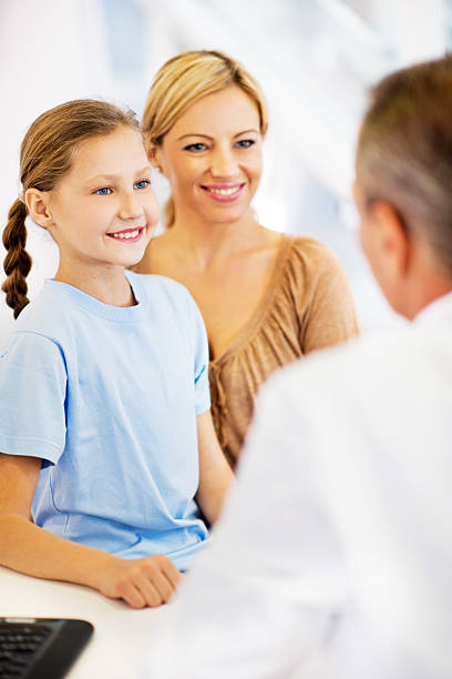 istock Happy mother and daughter at the doctor's office. 471446095