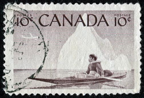 Cancelled Stamp From Canada Featuring An Inuit Man In A Canoe Riding Through The Arctic