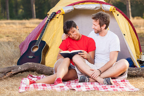 istock Young Couple Camping and Reading a Book 471448171