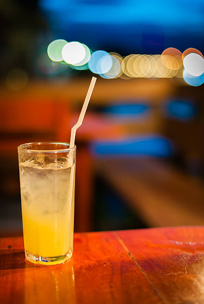 istock Orange juice on table with color of light 471448713