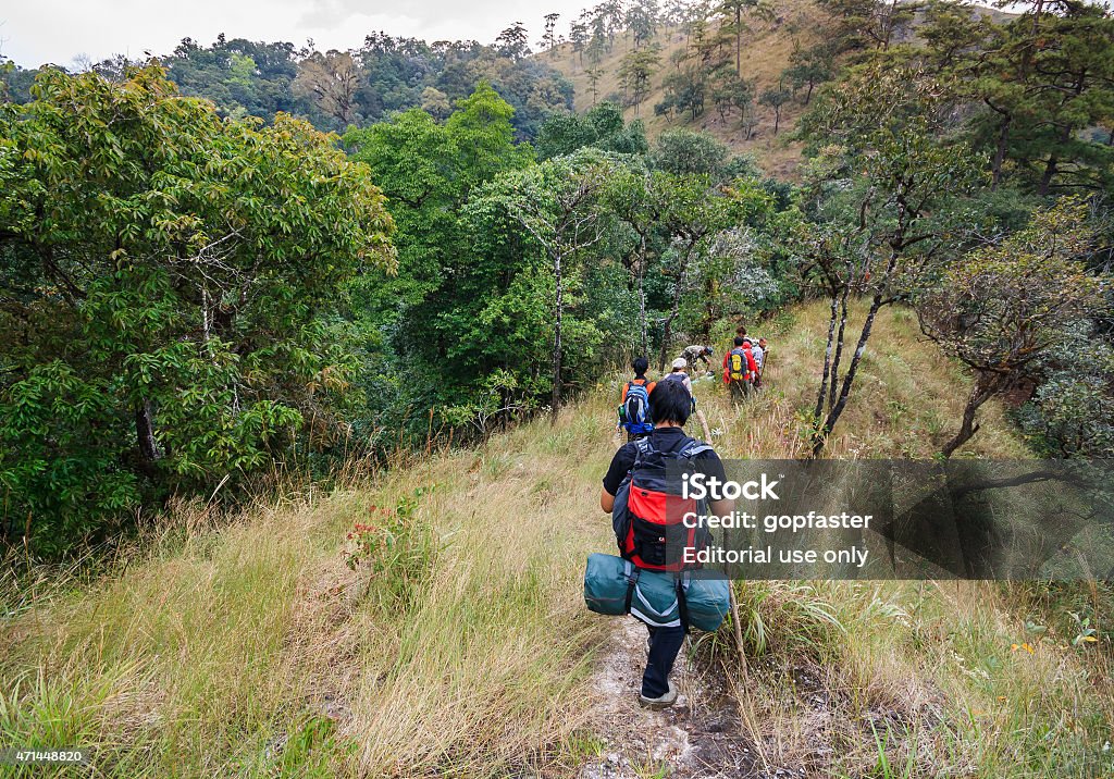traveler backpacker walk along on a trail on the ridge. Chiangmai,Amphoe Doi Saket Thailand - December 4, 2011:  traveler backpacker walk along on a trail on the ridge of mountain at the Doi Langka Luang Mt. in Khun Jae National Park. 2015 Stock Photo