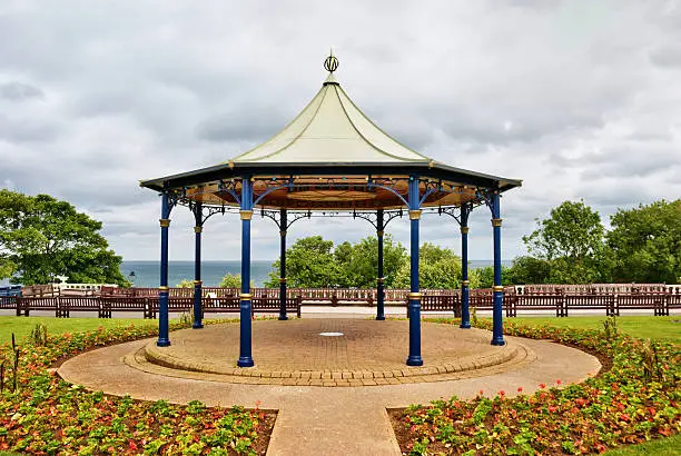 An ornamental English bandstand under an overcast sky in the seaside resort of Bridlington, North Yorkshire