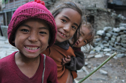 Annapurna, Nepal - April 4, 2006: Nepalese village child smiling in a village along the Annapurna circuit trek 