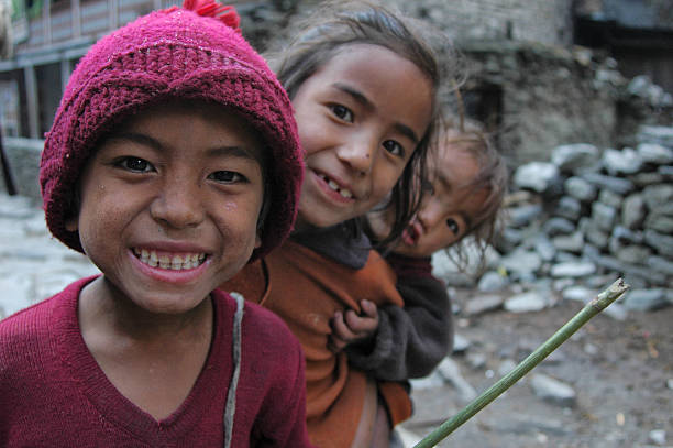 Nepalese village childrens smiling Annapurna, Nepal - April 4, 2006: Nepalese village child smiling in a village along the Annapurna circuit trek  annapurna circuit photos stock pictures, royalty-free photos & images