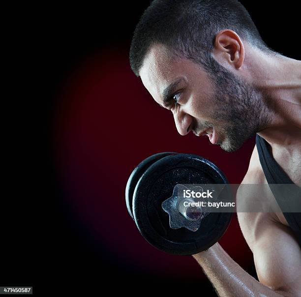 Grimacing Man Lifting Weights Stock Photo - Download Image Now - Grimacing, Men, Only Men