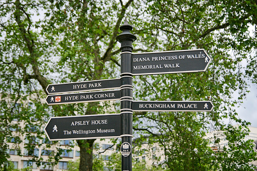 Footpath Sign to Hyde Park Corner in City of Westminster, London. It also shows the way to Trafalgar Square, Charing Cross and Westminster, with the Royal Parks symbol at the top