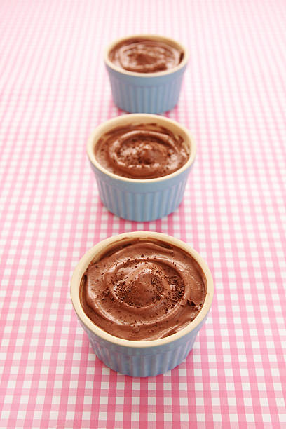 istock Chocolate mousse in blue bowls on pink tablecloth 471452079