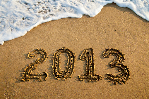 2013 written in sand with waves