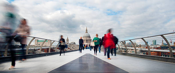 Commuters and Tourists on Millennium Bridge. St Pauls in Rear stock photo