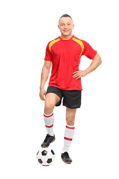 istock Young male soccer player standing over a ball 471453410