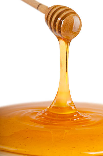 Honey dripping from dipper