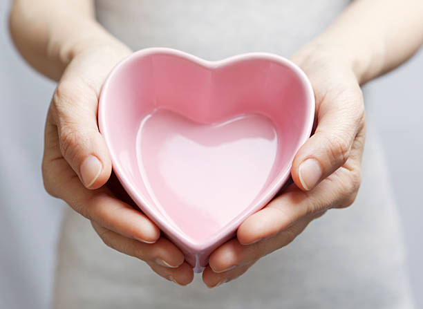 istock Holding pink heart bowl 471454597