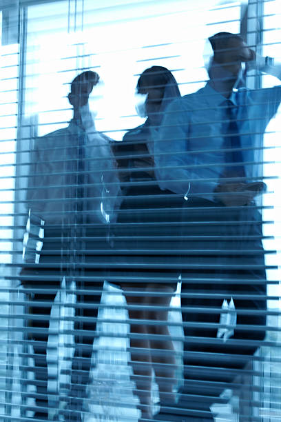 istock Business people behind jalousie 471455291