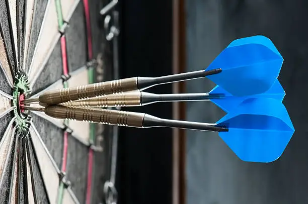 Three darts at the centre of a dartboard
