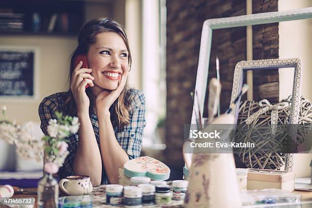 Young Home Designer On The Phone Stock Photo - Download Image Now - 20-29 Years, 2015, 30-39 Years