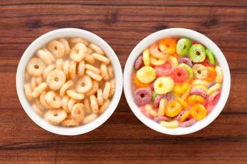 Colored breakfast cereals laid out in a bowl on a blue wooden background, top view, children's healthy breakfast.