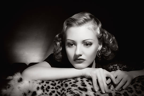 Film Noir style. Female portrait Emulation of vintage style photography.Grain added for more film effect. femme fatale stock pictures, royalty-free photos & images