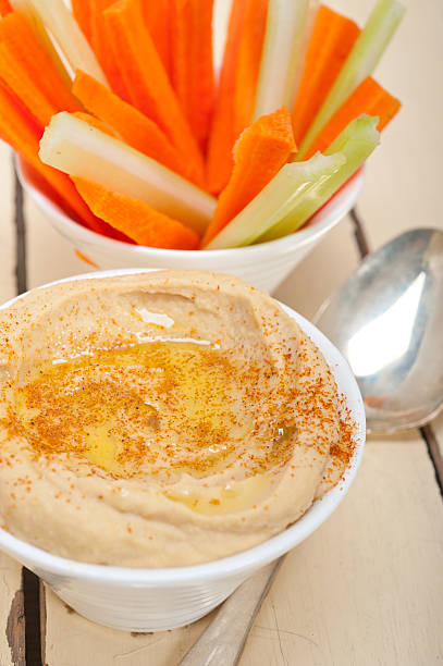 istock fresh hummus dip with raw carrot and celery 471455970