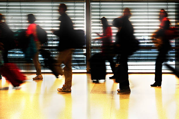 istock Modern airport terminal, travellers in silhouette 471457843