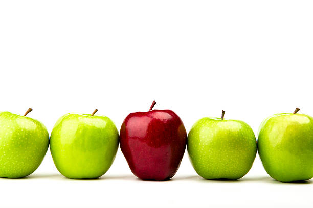 istock Red apple among green apples isolated on a white 471458185