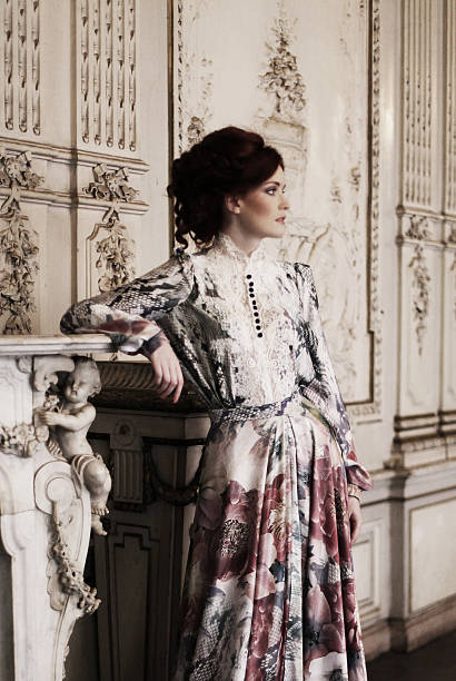istock woman  posing next to the fireplace 471458314