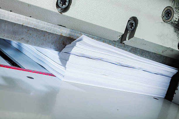 Paper in an automatic trimmer stock photo