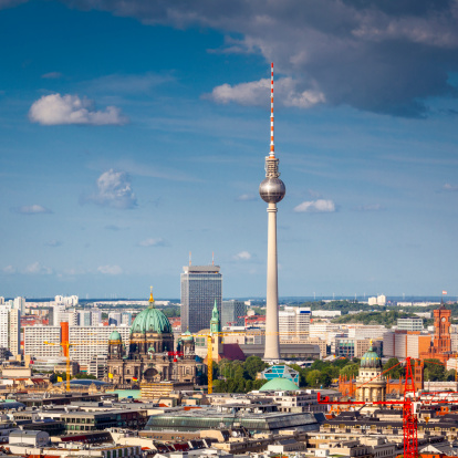 Iconic Fernsehturm television tower overlooking Berlin cityscape from a dizzying 1200 ft in the Alexanderplatz district. Many landmarks visible with the Berliner Dom sitting to the left of the communications tower.