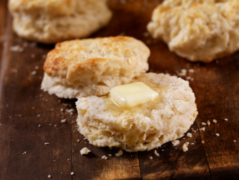 Homemade Buttermilk Biscuits Cooling on a Cutting Board with Melting Butter- Photographed on Hasselblad H3D2-39mb Camera