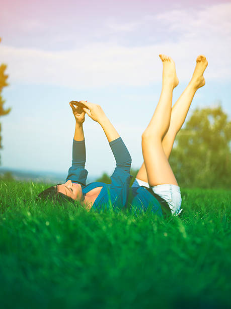 istock Young woman using mobile phone in park 471460377
