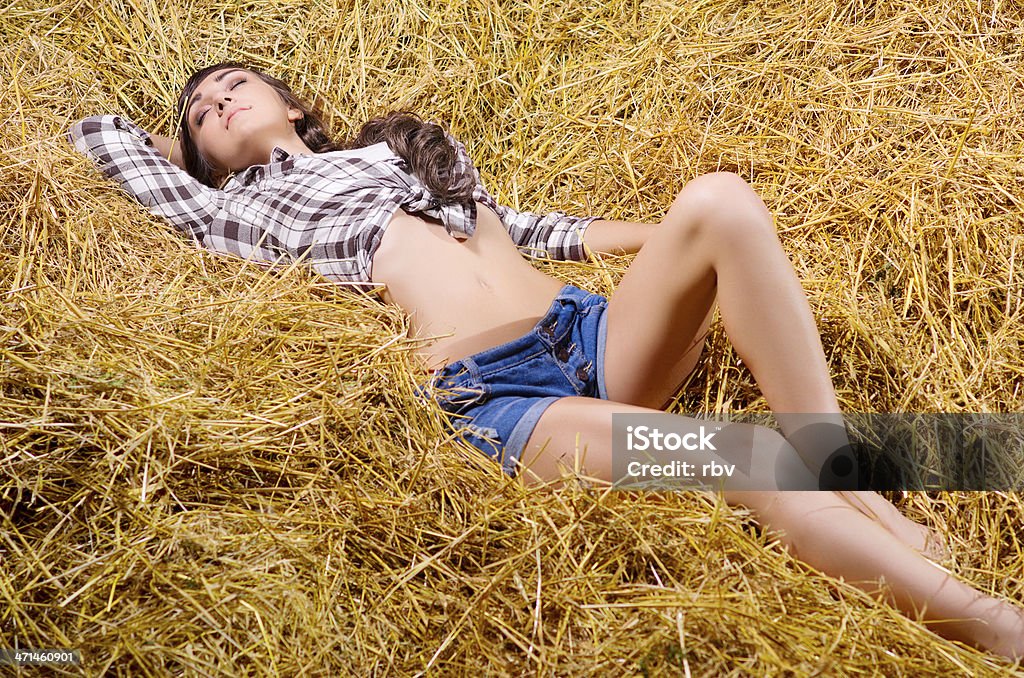 Girl lying on haystack Young girl lying on haystack 20-24 Years Stock Photo