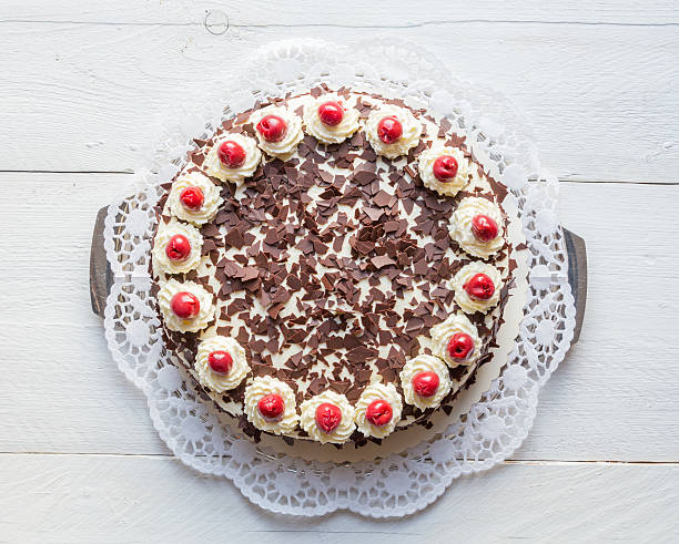 istock Black Forest cake on white wooden 471460936