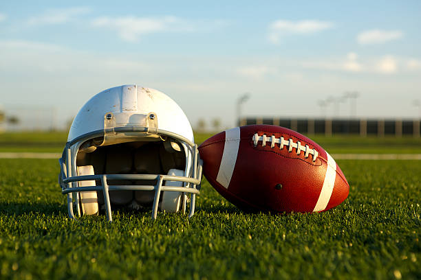 istock Football and Helmet on the Field 471463183