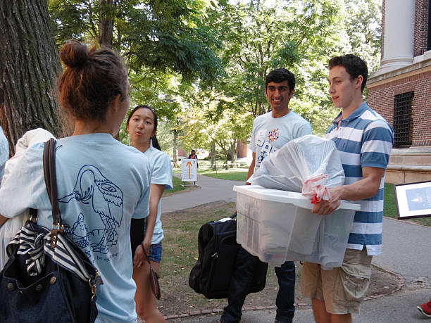 Harvard student volunteers helping a freshman moving-in stock photo