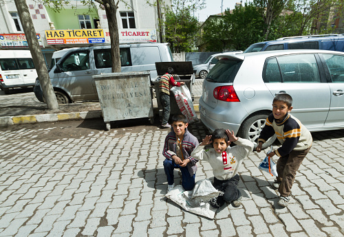 Agri, Turkey - May 13, 2012 : Kid workers collect things from garbage to sell in the street of Dogubeyazit,Agri/Turkey.
