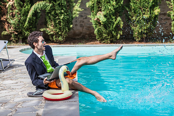 istock Funny Young Businessman with SwimmingTrunks next to the Pool 471464873