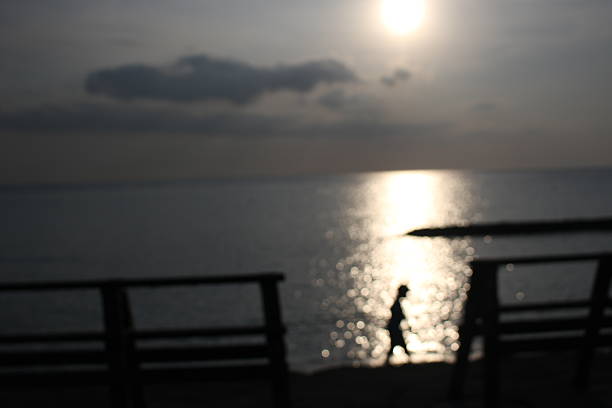 Beautiful sunset at a beach with blurred motion, the light is shining on the sea, Okinawa, Japan