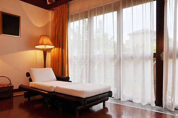 istock Chaise longue by the glass door 471465267