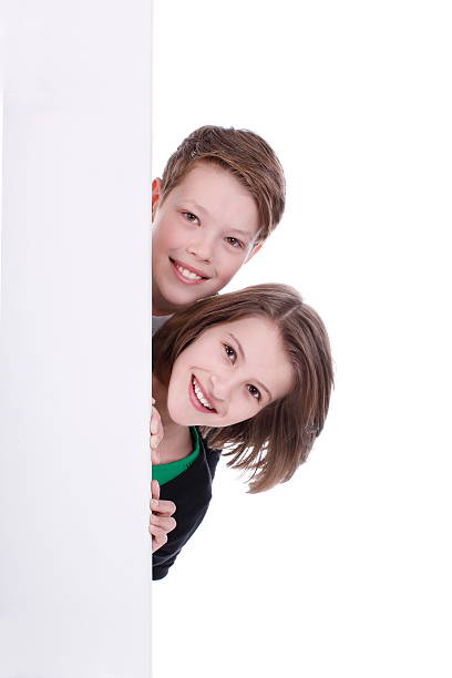 istock Boy and girl are looking round the corner 471465304